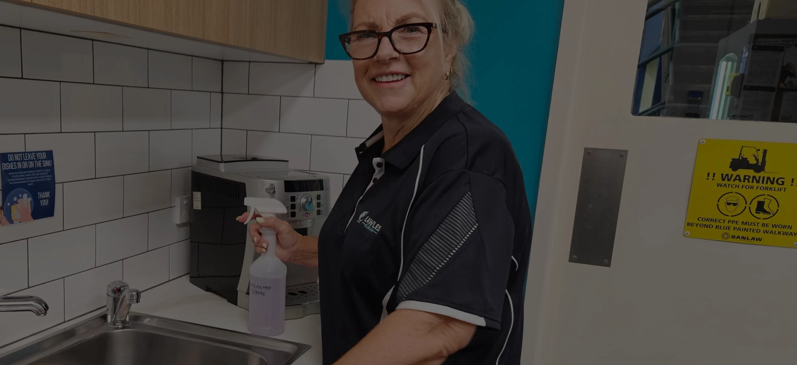 Flawless Clean team member preparing cleaning equipment in a workplace kitchen